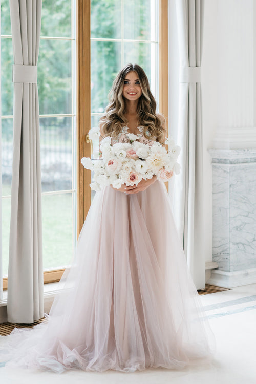 Blush pink wedding dress with floral embroidered top